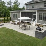 Close up of an outdoor living space with a stone grill and fire pit.